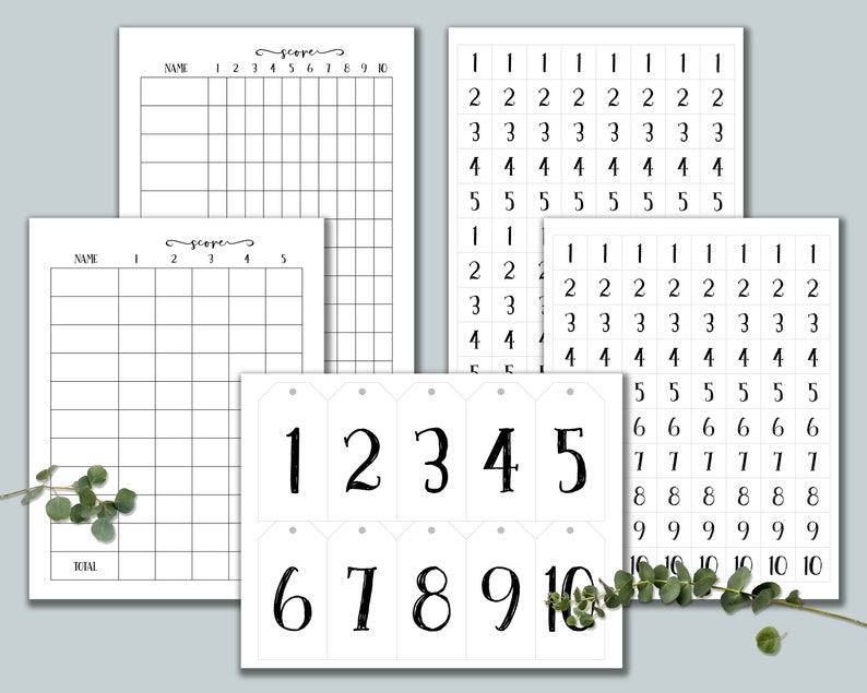 May include: Black and white printable scorecards with numbers 1 through 10. The scorecards are designed for a game or activity. There are also black and white printable number tags with numbers 1 through 10.