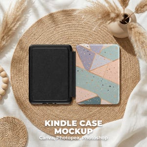 May include: A black Kindle case mockup, open to display the interior and the cover design. The cover features a geometric pattern in pastel colors: pink, blue, and purple. The case is displayed on a woven mat with decorative elements.