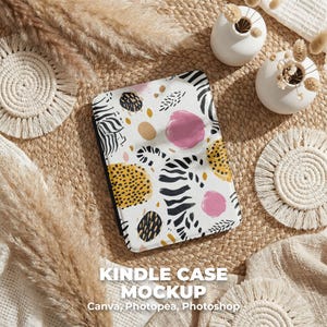 May include: Kindle case mockup with a white background and a colorful abstract pattern. The pattern includes black zebra stripes, yellow spots, pink circles, and brown ovals. The text "Kindle Case Mockup" is at the bottom.