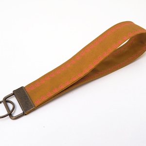 Oilskin lanyard with floral embroidery