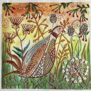 May include: Embroidered artwork depicting a bird amongst stylized plants and flowers. The bird's feathers are detailed in brown, tan, and blue. The background fades from green to yellow and orange, with red berries and white flowers.