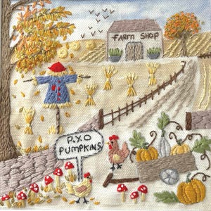 May include: A square fabric embroidery depicting an autumn farm scene with a scarecrow, a building labelled FARM SHOP, and a sign reading P.Y.O PUMPKINS. The scene includes orange pumpkins, two chickens, red mushrooms, wheat sheaves, and trees with yellow leaves.
