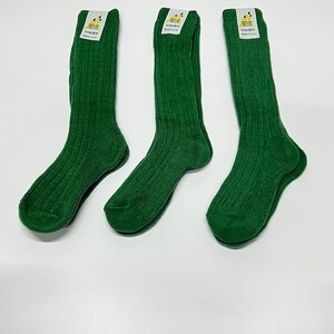 May include: Three pairs of dark green ribbed socks with a yellow and white label that says "Sugar & Spice" and "Made in UK".