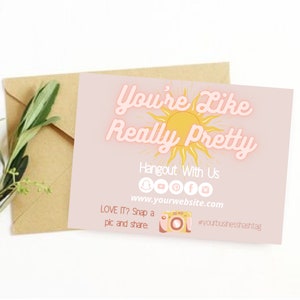 May include: A pink and yellow card with the text "You're Like Really Pretty" in a retro font. The card features a sun graphic and social media icons. The text "Hangout With Us" and "www.yourwebsite.com" are also included. The card encourages viewers to take a picture and share it with the hashtag #yourbusinesshashtag.