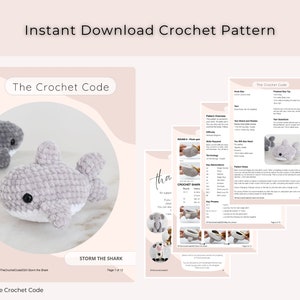 May include: A digital crochet pattern download featuring instructions for a shark plushie. The pattern includes detailed diagrams and the text "Instant Download Crochet Pattern" and "The Crochet Code". The finished shark is gray with white accents.