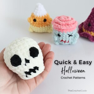 May include: A selection of handmade crochet Halloween decorations. Includes a white skull, a candy corn, a zombie cupcake, and a witch's hat. The text "Quick & Easy Halloween Crochet Patterns" is also visible.