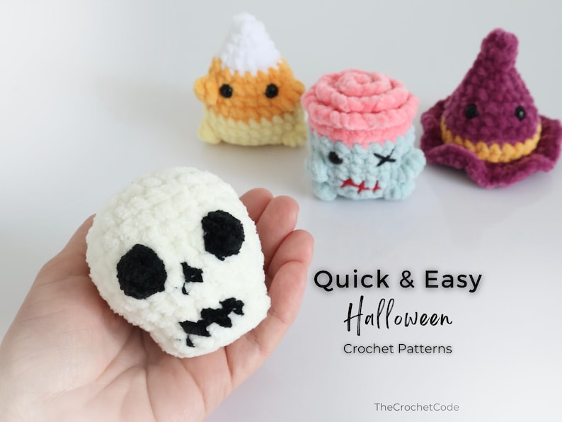 May include: A selection of handmade crochet Halloween decorations. Includes a white skull, a candy corn, a zombie cupcake, and a witch's hat. The text "Quick & Easy Halloween Crochet Patterns" is also visible.