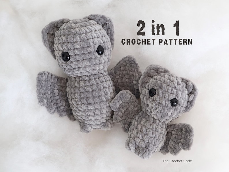May include: Two crocheted gray bat plushies, one larger than the other, with black eyes. The text "2 in 1 CROCHET PATTERN" is above the plushies.