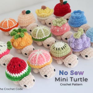 May include: A collection of crocheted mini turtles, each adorned with a different fruit design. The turtles feature various colors, including orange, red, green, and pink, and are arranged on a white surface. The text "No Sew Mini Turtle Crochet Pattern" is visible.