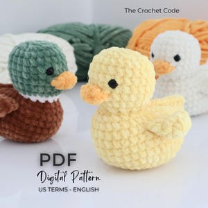 May include: Crocheted ducklings in brown, yellow, and white, with orange beaks and black eyes. The image includes the text "The Crochet Code" and "PDF Digital Pattern US Terms - English". The ducks are set against a backdrop of yarn.