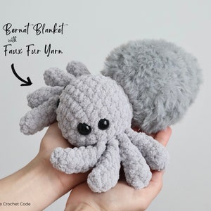 A beautiful spider made with textured blanket yarn and a furry faux fur yarn body.