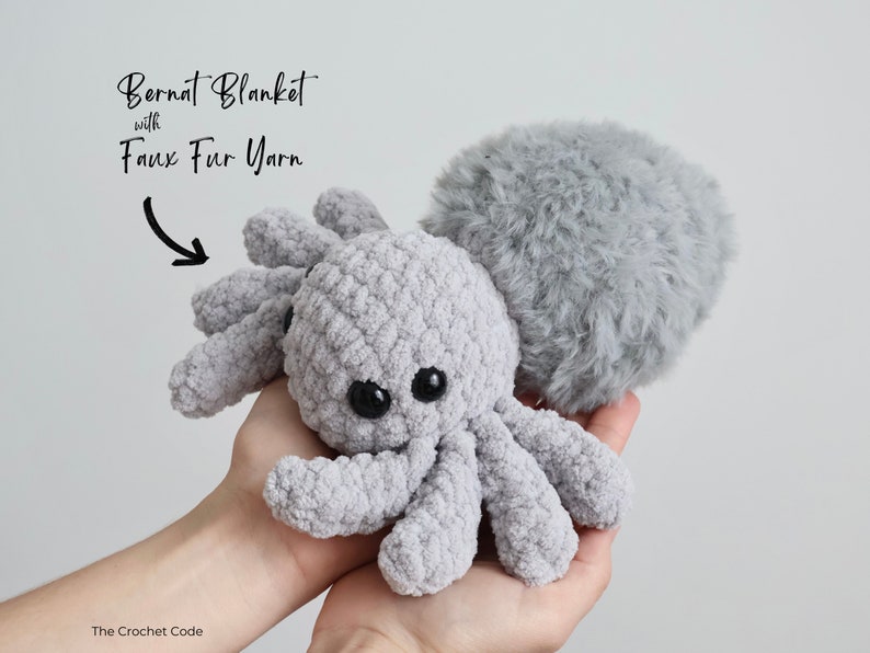 A beautiful spider made with textured blanket yarn and a furry faux fur yarn body.