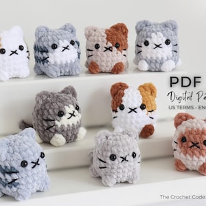 May include: A collection of handmade crochet cat plushies in various colors, including white, gray, and brown. Each cat has a unique pattern and embroidered facial features. The image also includes the text "PDF Digital Pattern US TERMS - ENGLISH".