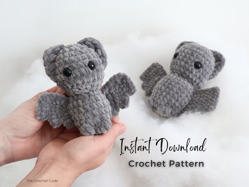 May include: A crochet pattern for a gray bat amigurumi toy. The pattern is available for instant download. The image shows two finished bats, one being held in a person's hands.