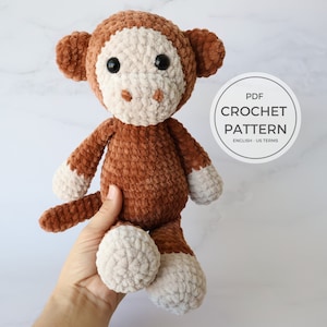 May include: Crochet pattern PDF for a brown and white plush monkey toy. The PDF is in English and uses US crochet terms.