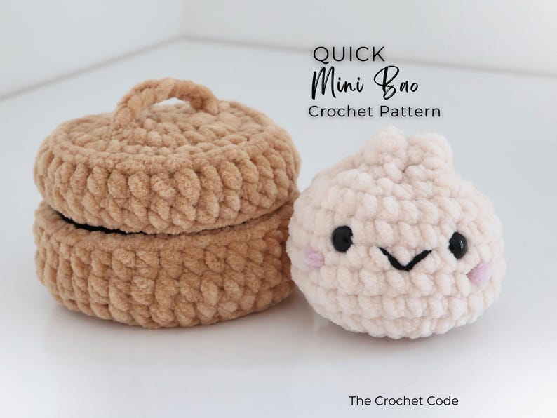 May include: A tan crocheted lidded container and a light pink crocheted bao bun with black eyes, a black stitched mouth, and pink cheeks. The text reads QUICK Mini Bao Crochet Pattern and The Crochet Code.