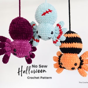Hung upside down from a height this image displays 3 spiders purple, green and orange with their crocheted legs spread out touching each other.