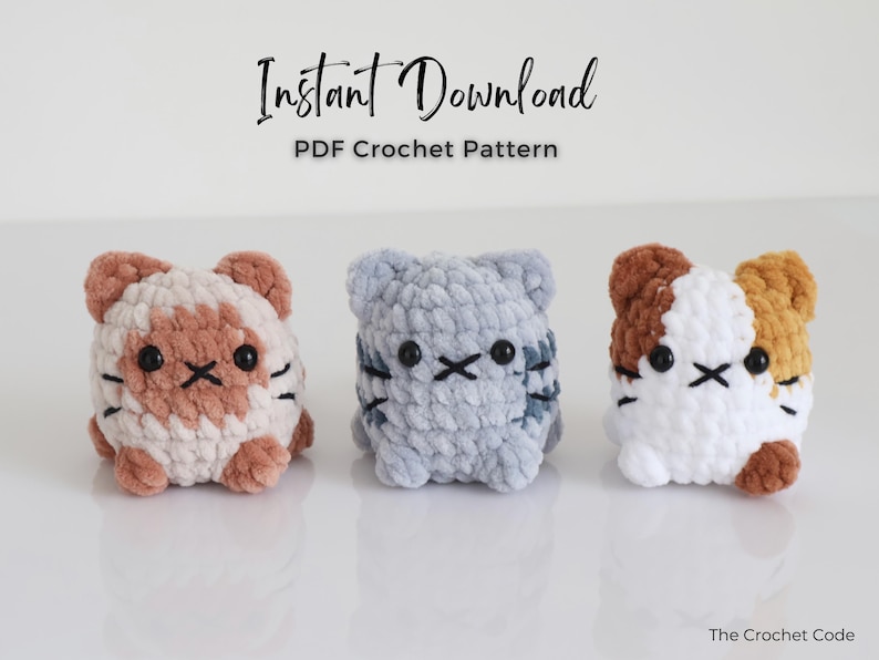May include: Three crocheted cat toys in a row. The cats are in shades of brown, gray, and white. Each cat has black eyes and whiskers. The text "Instant Download PDF Crochet Pattern" is at the top of the image.