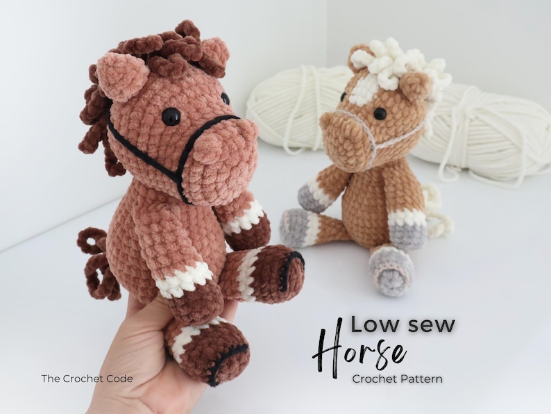 Two handmade crochet horse plushies in shades of brown, white, and gray. One is held by a hand. The text "Low sew Horse Crochet Pattern" is visible. The horses have black eyes and are made of soft yarn.