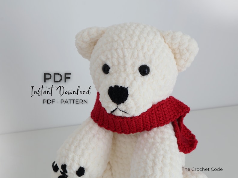May include: A handmade white crochet polar bear with a red scarf. The bear has black eyes and a black nose. The text "PDF Instant Download PDF - PATTERN" is in the upper left corner. The Crochet Code is in the lower right corner.