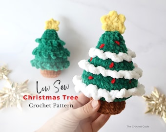 May include: A crochet Christmas tree pattern with the text "Low Sew Christmas Tree Crochet Pattern". The tree is green with white and red accents. The tree is topped with a yellow star.