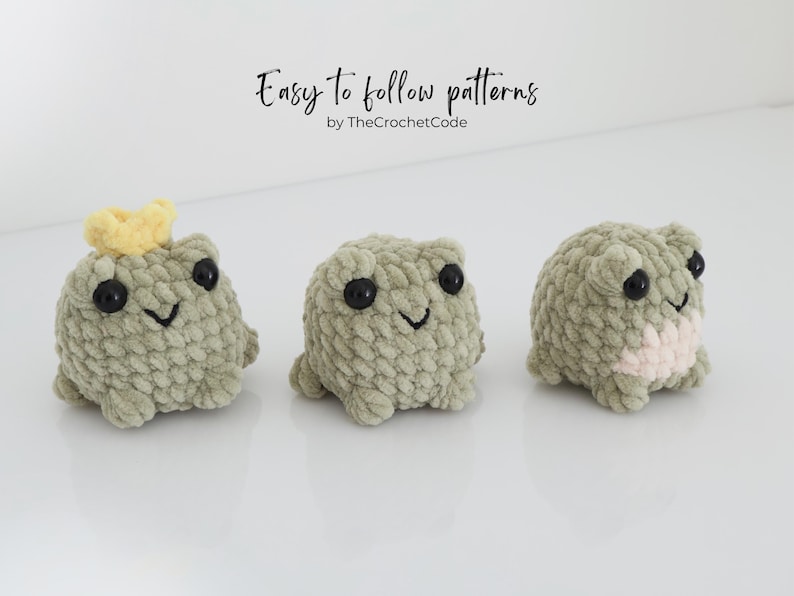 May include: Three crocheted frog plushies in shades of green, each with black eyes and a smiling mouth. One frog wears a yellow crown. The text "Easy to follow patterns" is above the frogs.