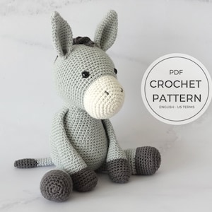 May include: Crochet pattern for a gray donkey amigurumi toy. The pattern is available as a PDF download and includes instructions in US English terms.