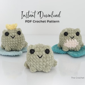 May include: Three handmade crochet frog toys in shades of green, each with black button eyes and a stitched smile. One frog wears a yellow crown. They sit on blue lily pads. The text "Instant Download PDF Crochet Pattern" is above them.