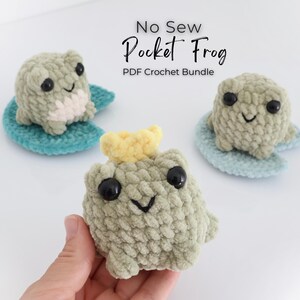 May include: Three handmade crochet frogs in shades of green, sitting on blue lily pads. One frog has a yellow crown. The text "No Sew Pocket Frog PDF Crochet Bundle" is at the top. The frogs have black eyes and smiling faces.