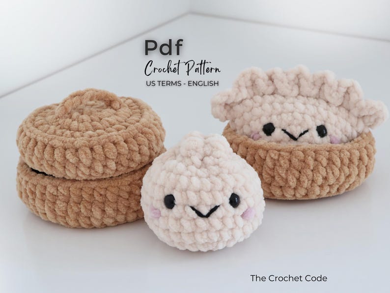 May include: A PDF crochet pattern titled The Crochet Code featuring instructions for plush items including a tan lidded container, a small cream-colored round dumpling, and a cream-colored dumpling with a ruffled edge inside a tan bowl.