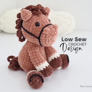 A handmade, plush crochet horse in shades of brown, with white accents on its legs. The horse has a black bridle and dark brown mane and tail. The text "Low Sew Crochet Design" is displayed on the right side of the image.