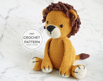 May include: Crochet pattern for a lion amigurumi toy. The lion is sitting with its legs crossed and has a brown mane, a yellow body, and white paws with black claws. The pattern is in English and uses US terms.