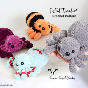 Being held in the foreground is a foggy grey single toned crochet spider looking forwards. It lays infront of 3 other spiders. Each made with a unique colour change crochet combination