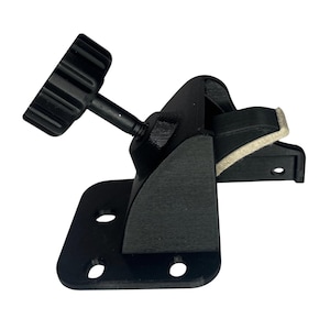 May include: A black mounting bracket with a textured knob and adjustable arm. The bracket has a rectangular base with three holes and a padded clamp. The design is made of a matte black material.