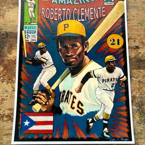 May include: A vibrant comic-style print featuring Roberto Clemente, a baseball player, with the text "the AMAZING ROBERTO CLEMENTE." The artwork includes images of Clemente in action, the Puerto Rican flag, and the Pirates logo. The print is framed.