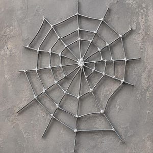 Large handcrafted metal spider web wall decor, 50 x 50 cm, made from 3 mm wire with a natural metallic lacquer finish, perfect for gothic and Halloween interiors.