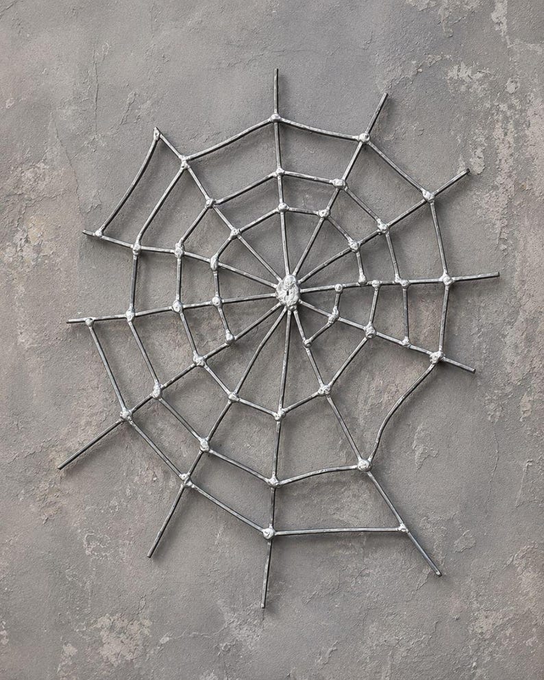 Large handcrafted metal spider web wall decor, 50 x 50 cm, made from 3 mm wire with a natural metallic lacquer finish, perfect for gothic and Halloween interiors.
