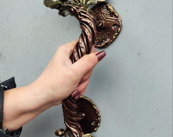 A wrought iron handle in the shape of an oak branch with acorns — an exclusive, handcrafted door handle.