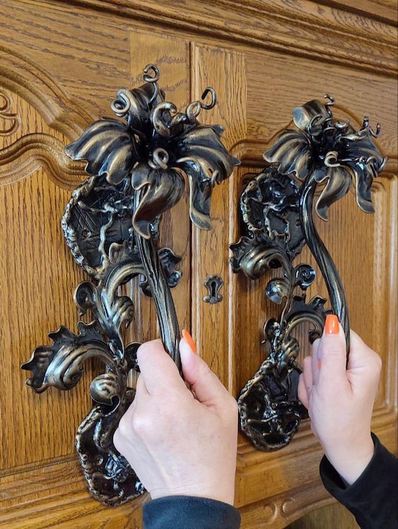 A blacksmith hand-forged iron door handles shaped like blooming lilies — your front door becomes the most striking thing on the street.