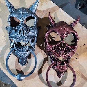 Door handle. The knock on the door in the shape of a skull. Halloween party.  Forged skull. Horned skull Kіltse-Door handle