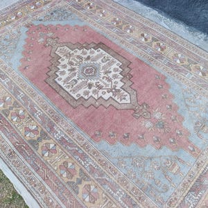 May include: A handmade wooden sign with the text "Welcome to our home" in a handwritten style. The sign is painted white with black lettering and a distressed finish, perfect for home decor.