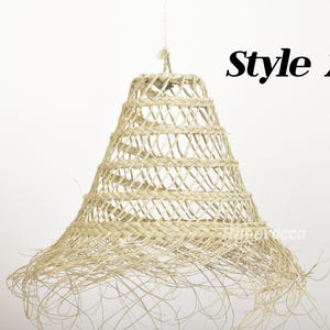May include: A woven, natural fiber pendant light fixture with a bell shape and a fringed bottom. The light fixture is labeled "Style 2".