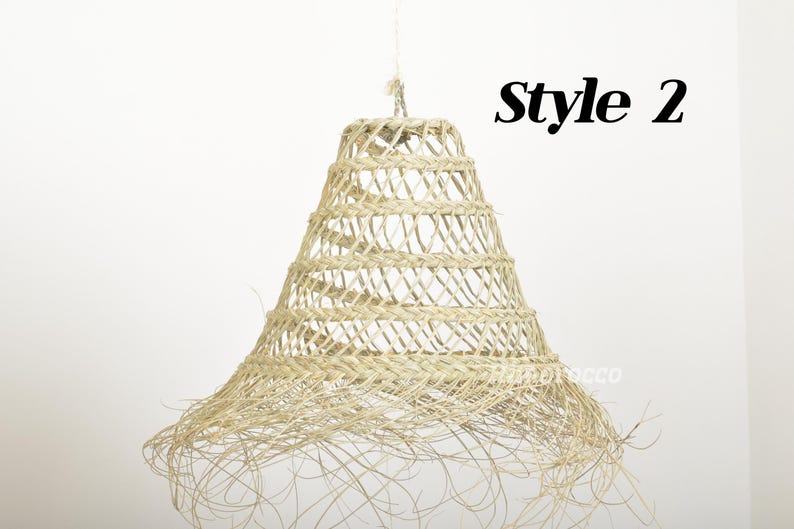May include: A woven, natural fiber pendant light fixture with a bell shape and a fringed bottom. The light fixture is labeled "Style 2".