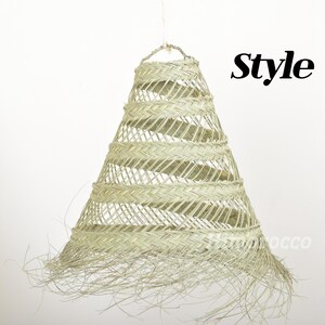 May include: A woven, light beige, cone-shaped lampshade with a fringe trim. The lampshade is labeled "Style 3".