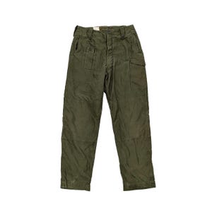May include: Olive green cargo trousers with multiple pockets and a button closure. The trousers have a straight leg design and appear to be made of a durable fabric. The trousers have a vintage or military style.