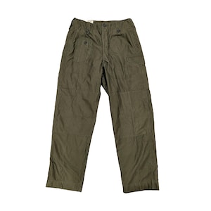 May include: Olive green cargo pants with multiple pockets and button closures. The pants have a relaxed fit and a slightly faded appearance. The fabric appears to be a durable, possibly military-style material.