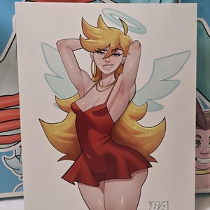 May include: Illustration of a woman with blonde hair, wearing a red dress, angel wings, and a halo. The artwork has a cartoon style. The artist's signature "BA BlazinAlley" is in the bottom right corner.
