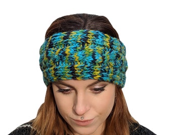 May include: A blue, yellow, and black knit headband. The headband is thick and has a cable knit pattern.