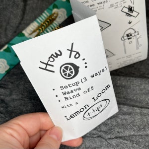 May include: A white card with black text that reads "How to... Setup (3 ways) Weave Bind off with a Lemon Loom +tips". The card has a small lemon illustration with a slice cut out.