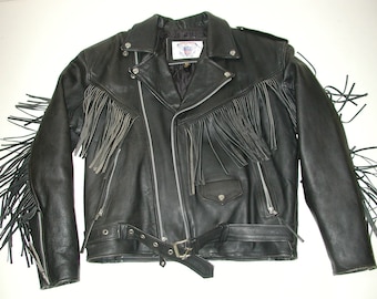 May include: Black leather motorcycle jacket with fringe detailing on the sleeves and a belt at the waist.